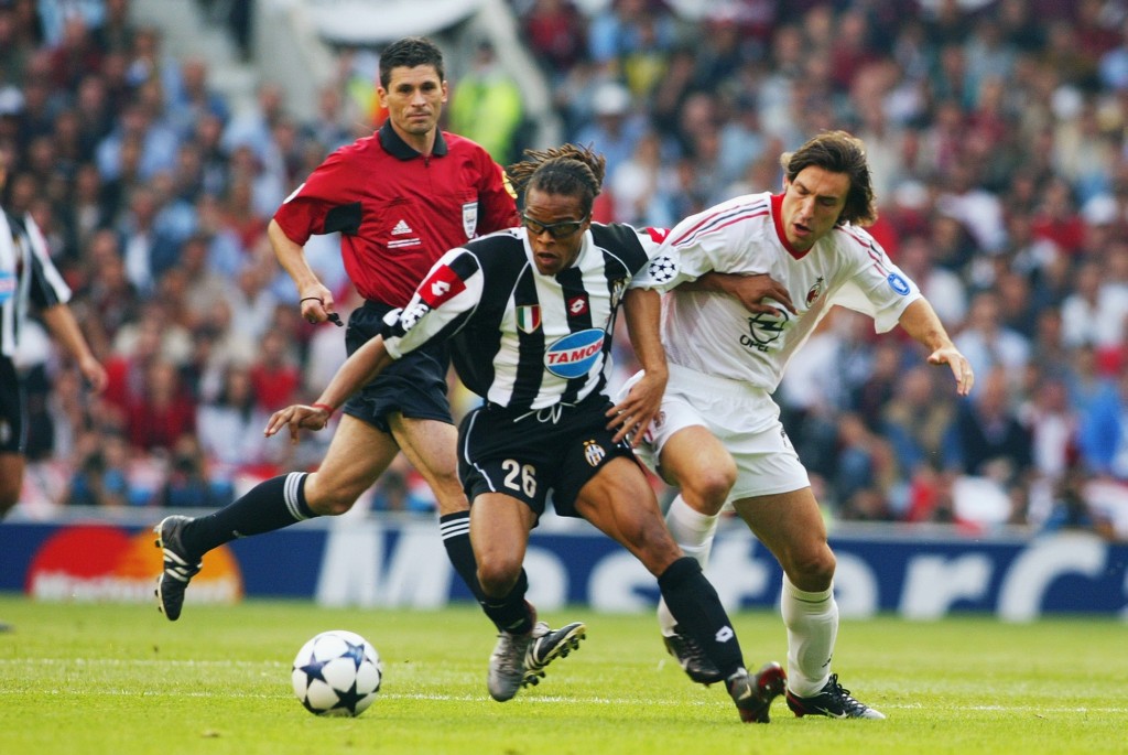 Rui Costa of AC Milan challenges Edgar Davids of Juventus