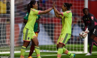 Champions Japan qualify for knockout stage