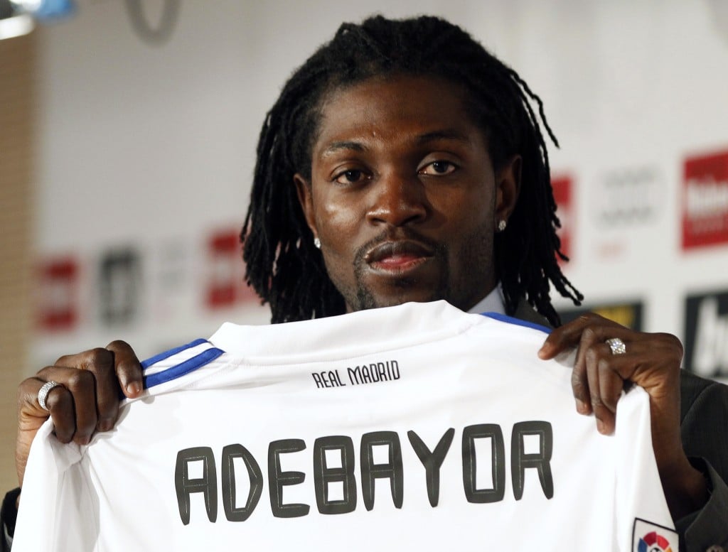 Emmanuel Adebayor holds up his new Real Madrid jersey during a presentation at the Bernabeu stadium in Madrid