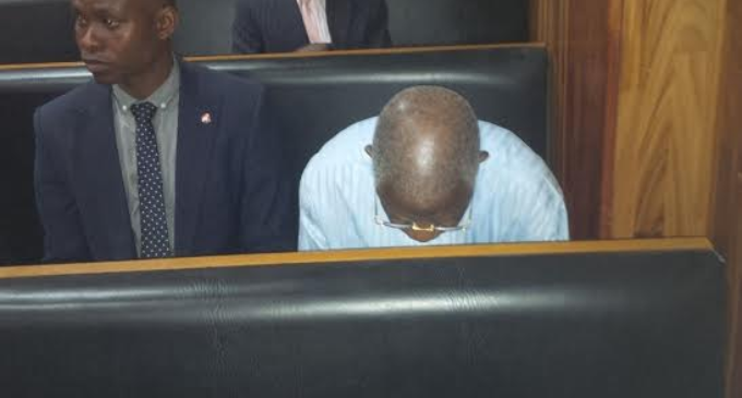EXTRA: Oronsaye hides from cameras in court