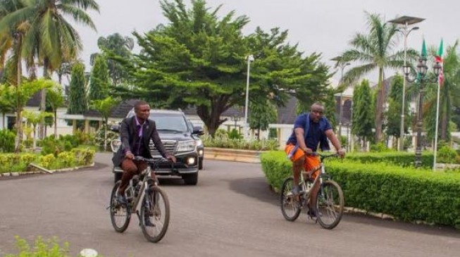 EXTRA: Okorocha abandons convoy, rides bicycle on streets of Owerri
