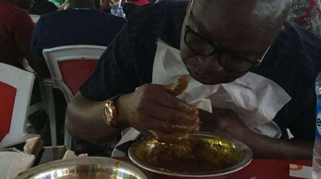 EXTRA: Fayose enjoys amala in Abuja restaurant