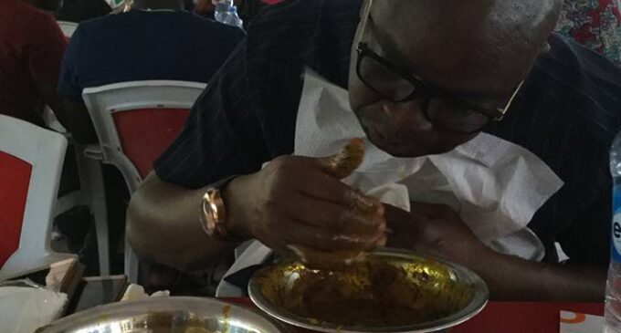 EXTRA: Fayose enjoys amala in Abuja restaurant