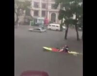 Foreigner paddles canoe on the flooded streets of VI