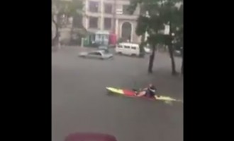 Foreigner paddles canoe on the flooded streets of VI