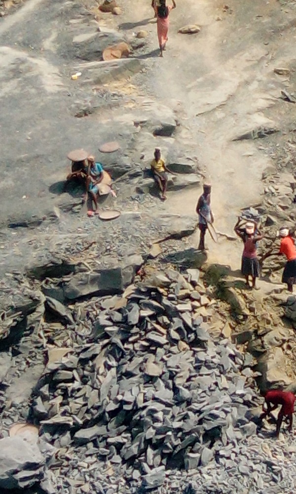 Children taking turns to fetch stones out of the pit