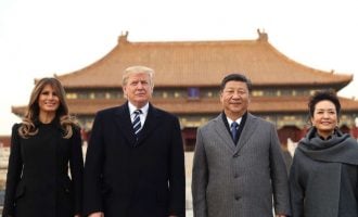 Dollar wobbles as Trump lands in China