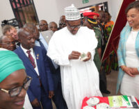 PHOTOS: Buhari counts fake dollars at new EFCC head office