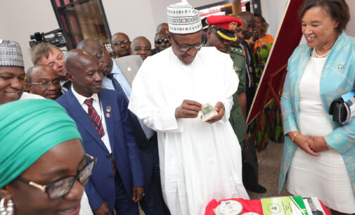 PHOTOS: Buhari counts fake dollars at new EFCC head office