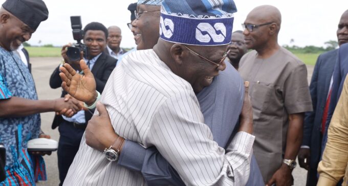 PHOTOS: Tinubu hugs Atiku at Akure airport