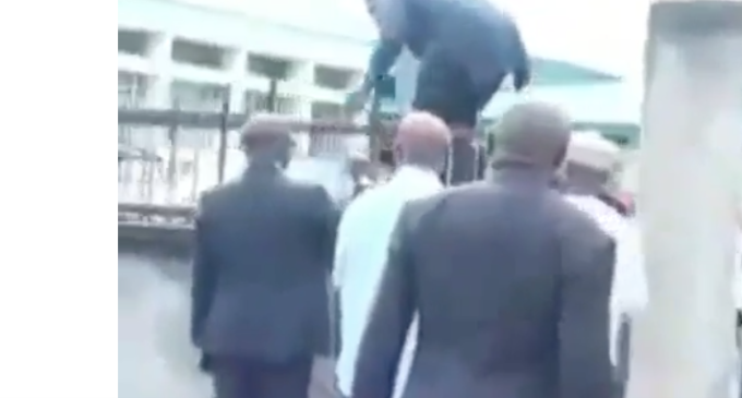 VIDEO: Benue lawmakers scale fence after police blockade