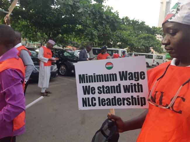 A protester flashing a placard in Abuja