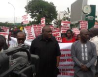 Senator-elect leads protesters to INEC headquarters over certificate of return