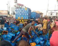 VIDEO: Residents shun social distancing to drink after truck conveying beer fell in Anambra