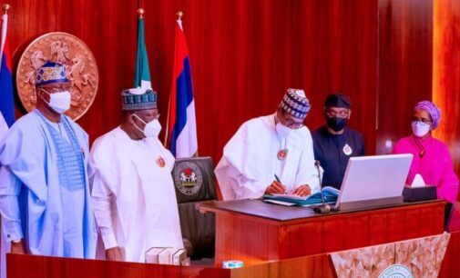 PHOTOS: Osinbajo absent as Buhari signs 2022 budget into law