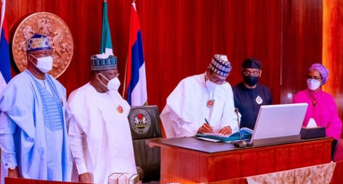 PHOTOS: Osinbajo absent as Buhari signs 2022 budget into law