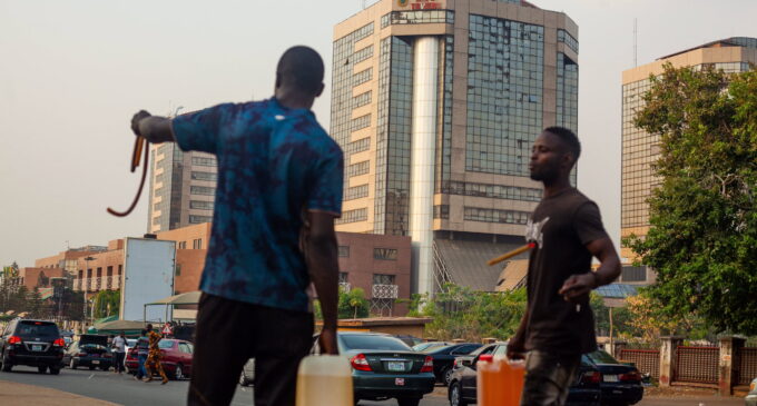 PHOTOS: Black marketeers loiter around NNPC Towers in Abuja, sell petrol in jerrycans