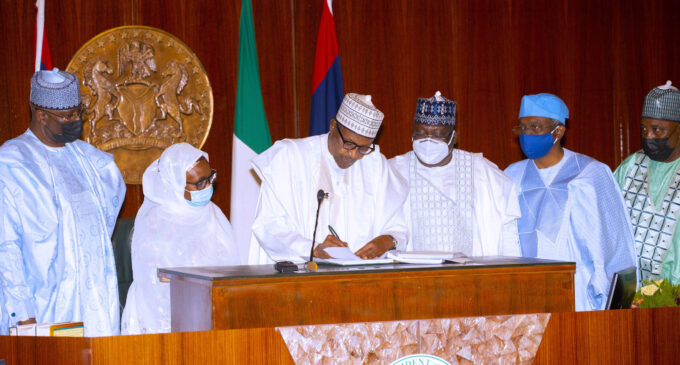 PHOTOS: Lawan, Gbaja present as Buhari finally signs electoral bill