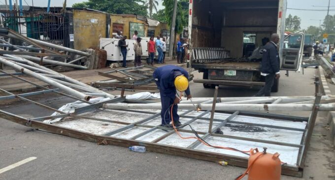 PHOTOS: Vehicles damaged as billboard falls in Lagos community