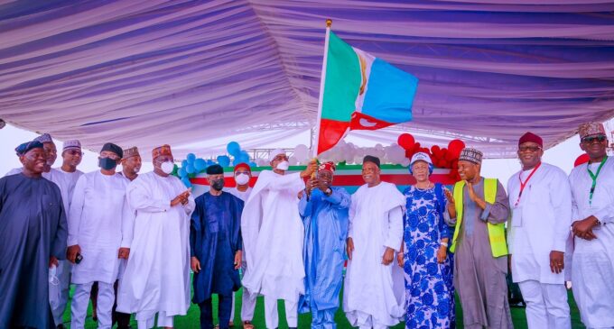 PHOTOS: Buhari presents APC flag to Tinubu