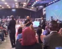 EXTRA: Drama as Abuja pastor brings AK 47 to altar