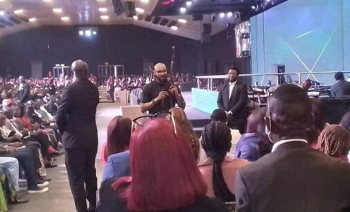 EXTRA: Drama as Abuja pastor brings AK 47 to altar