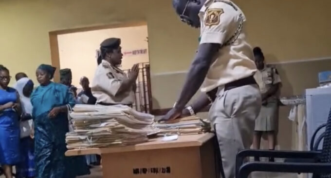 TRENDING VIDEO: ‘They’ll still collect bribe’ — reactions trail video of officers praying at Lagos passport office