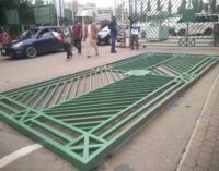 NLC protesters pull down national assembly gate, force their way into complex
