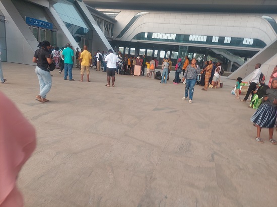 Passengers in queue at the entrance of the train station 