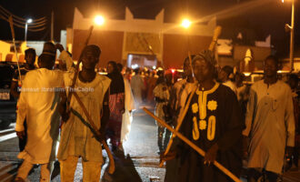 PHOTOS: Hunters stand guard as Sanusi remains in palace despite court order 