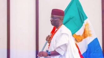 Monday Okpebholo with the APC flag