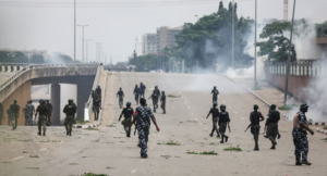 Police officers disperse protesters with teargas in Abuja during the nationwide marches against bad governance