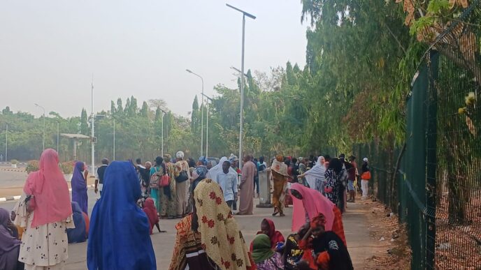 Pro-Natasha Akpoti supporters at the national assembly gate after police dispersed them with tear gas canisters