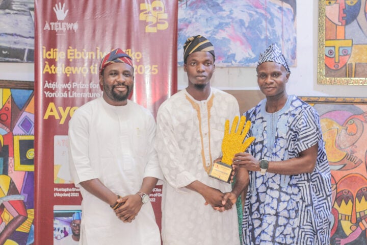 Oredola Ibrahim flanks Abdulrafiu as he receives the award from Tunde Lawuyi-Ogunniran Oredola Ibrahim.