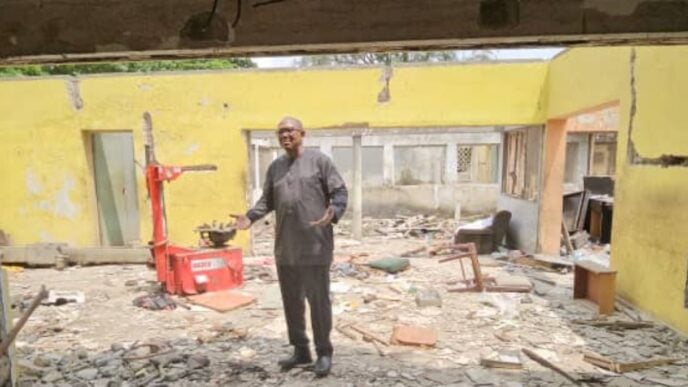 Peter Obi in the ruins of the demolished property