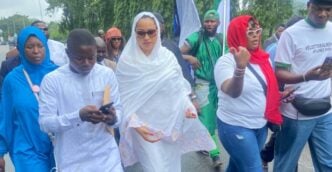 Natasha Akpoti (wearing white hijab) stormed the national assembly complex on Tuesday