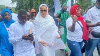 Natasha Akpoti (wearing white hijab) stormed the national assembly complex on Tuesday
