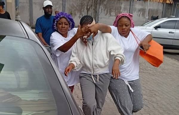 Emmanson (middle) being protected shortly after her release from Kikiri prison Photo credit: TVC