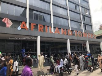 Traders back at the entrance of Afriland Towers after fire incident