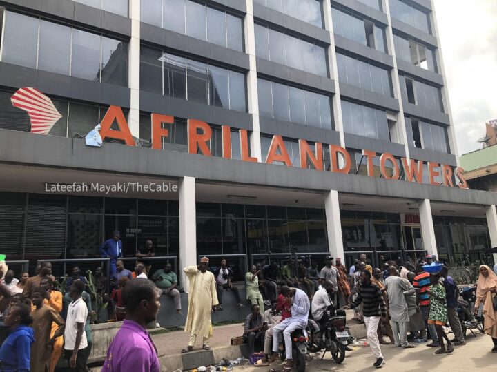Traders back at the entrance of Afriland Towers after fire incident