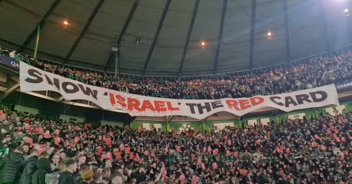 Fans with a banner calling for the ban of Israel from football over the country's war on Gaza