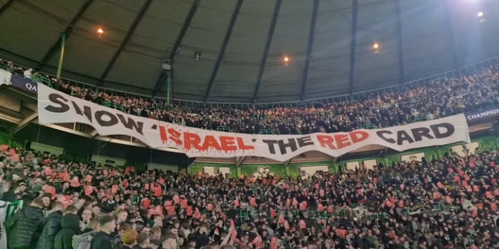 Fans with a banner calling for the ban of Israel from football over the country's war on Gaza
