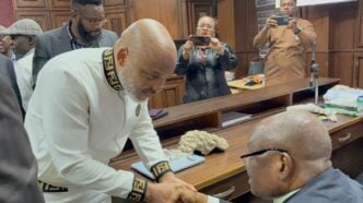 Nnamdi Kanu (in white fendi) in court. Staring at him is Kanu Agabi who led his legal team